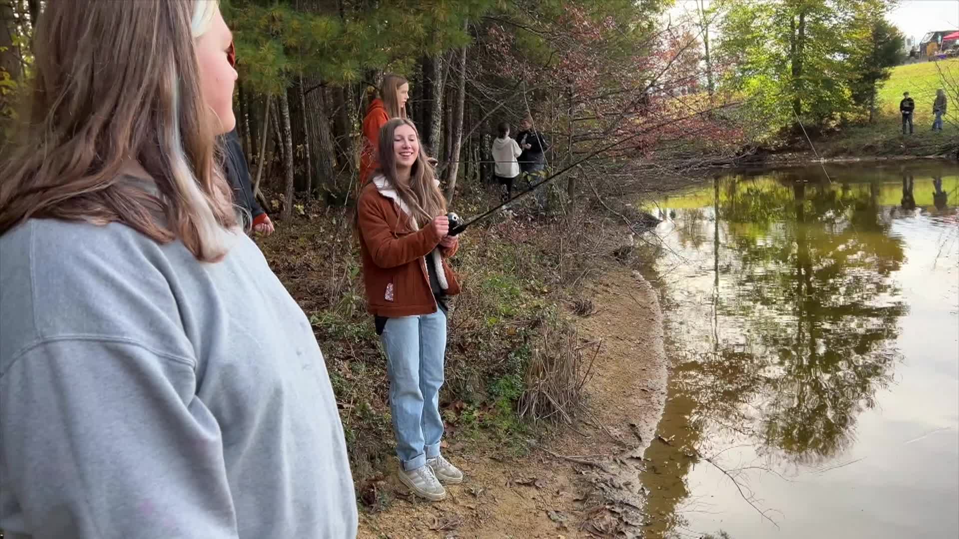 People standing by a creek on a nature walk