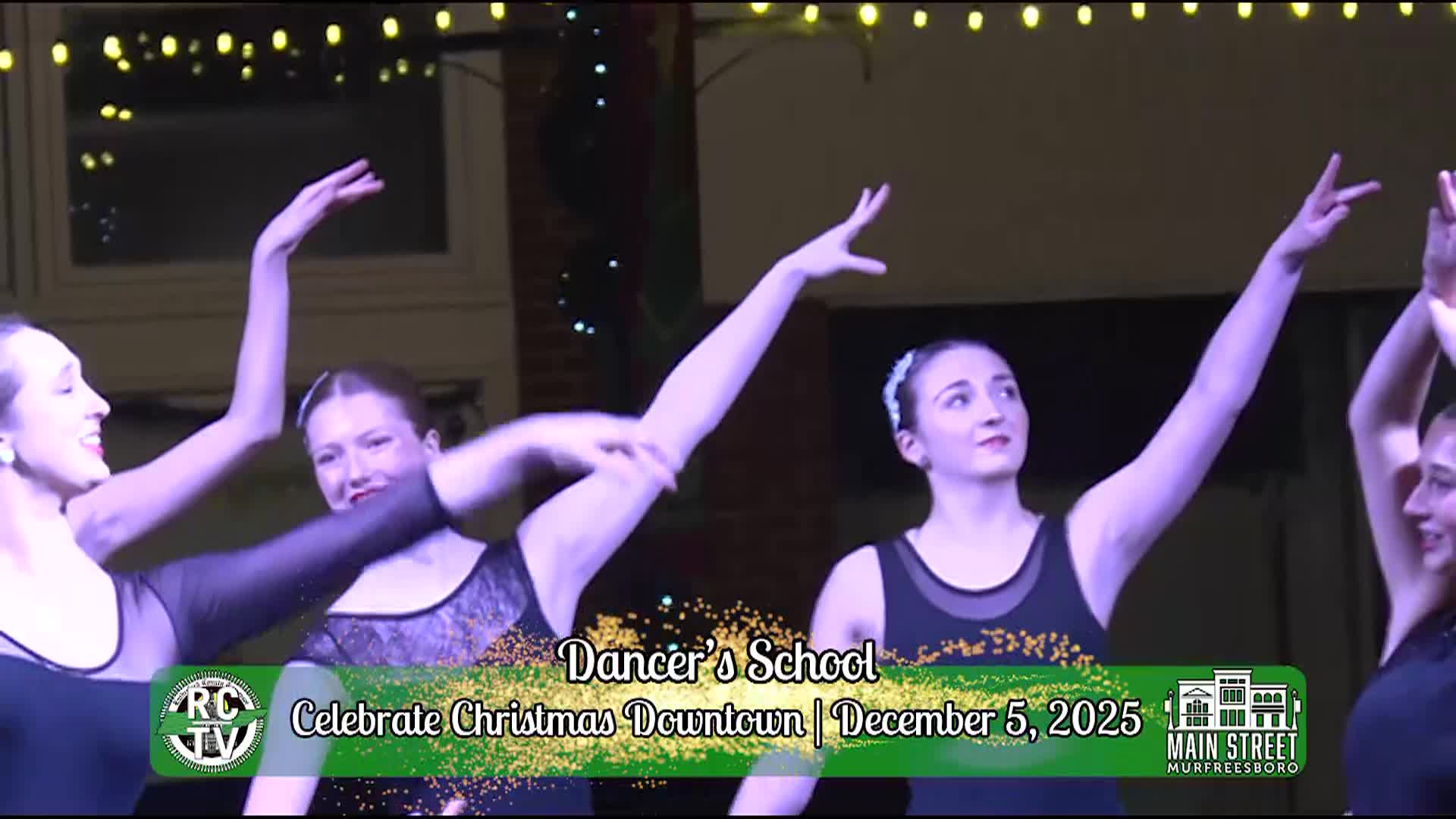 Dancers performing on a stage at the tree lighting event