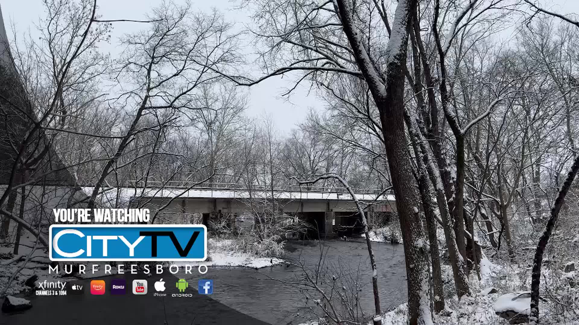 Shot of a bridge and river in Murfreesboro during a snowstorm