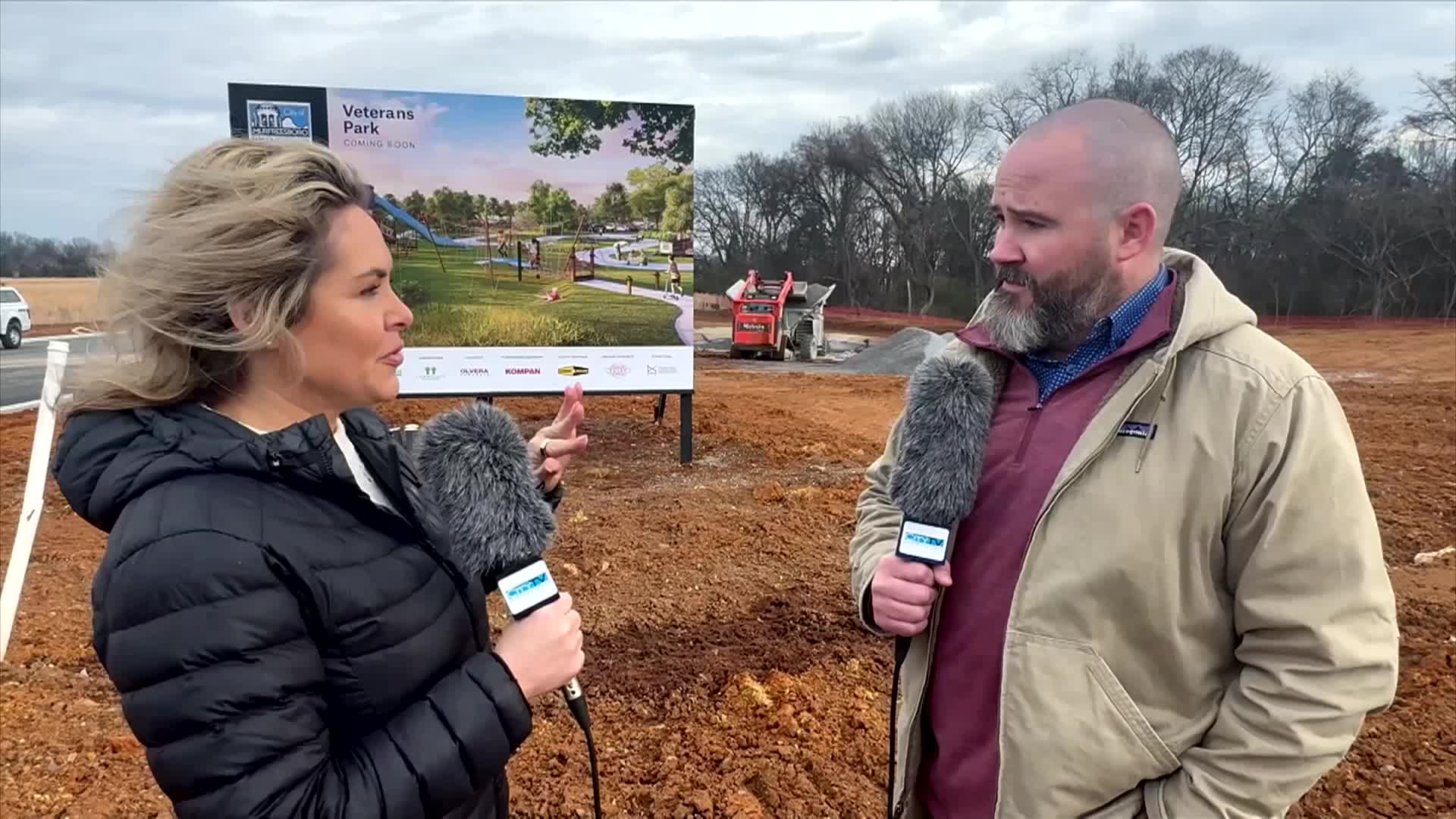 Man and woman talking about new park construction