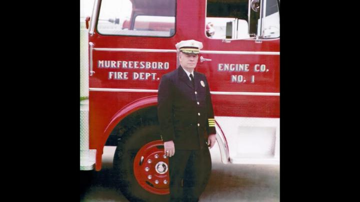 Fire Chief standing in front of fire truck