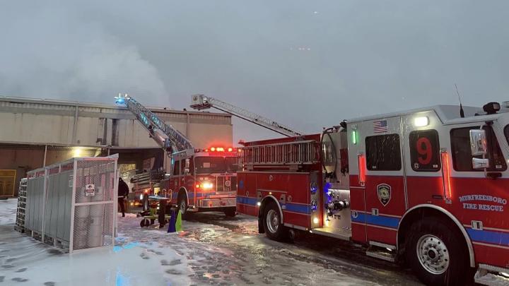 Fire truck outside building on snowy day