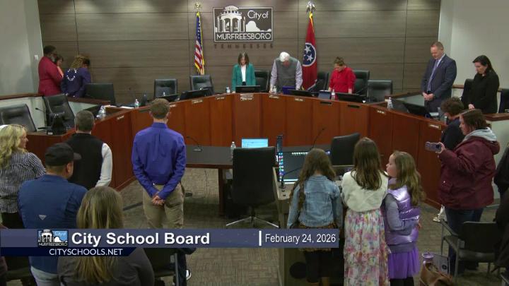 school board members and audience at meeting